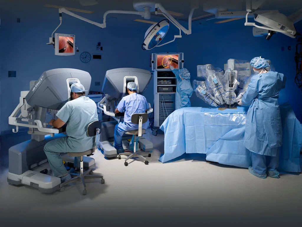 A photo of a robotic surgery setup with a surgeon at the console